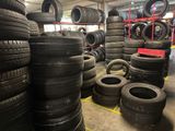 many tires stacked on the floor in a warehouse
