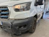 a white van that has been damaged and is in a garage