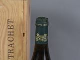 a bottle of wine sitting next to a wooden box