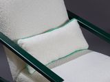 an image of a white chair with a green trim and a pillow