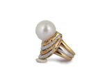a close up of a pearl and diamond ring on a white background