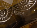a close up of a glass vase with a clock on it