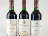 trois bouteilles de vin posées sur une table blanche