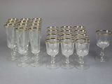 twelve glass goblets with gold rims and gold rims