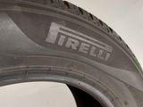 a close up of a tire on a white surface with a tire sticker on it
