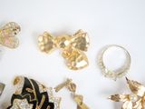 many different types of jewelry on a white surface