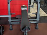 a gym equipment set up in a gym with a red wall