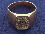 a close up of a gold ring with an eye on it