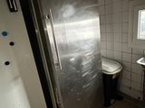 a stainless steel refrigerator and sink in a small kitchen