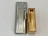 a lighter that is next to a lighter on a table