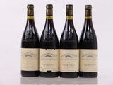 three bottles of wine are lined up on a table