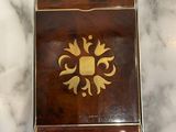 a small wooden box on a marble counter top