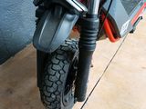 a close up of a motorcycle parked on a wooden floor
