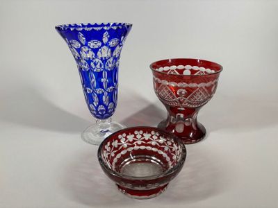 three glass vases sitting next to each other on a table