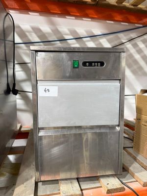 an image of a stainless steel ice machine in a warehouse