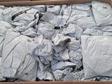 a cardboard box filled with white shirts and white sheets