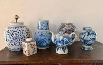 Plusieurs vases bleus et blancs sont posés sur une table en bois.