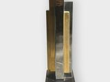 a metal sculpture that is on display on a white surface