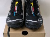 a pair of black running shoes on top of a cardboard box