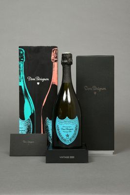 a bottle of champagne and a box of chocolates on a table