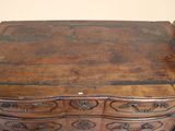 a small wooden table with a drawer on top of it