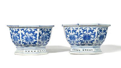 pair of blue and white vases with floral designs on stands