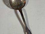 a spoon and a spoon rest on a white table