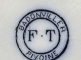 a white plate with a black and white logo on it