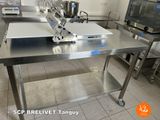 a kitchen with stainless steel tables and pots and pans on them
