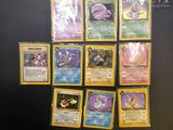 the pokemon cards are lined up on a black surface