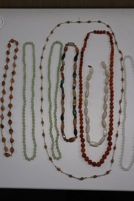 a lot of necklaces that are on a table
