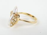 a close up of a gold ring with a pearl in it