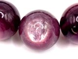 three plums on a white surface with a white background