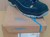men ' s shoes in a box on a table next to a cardboard box