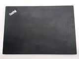 a black mouse pad on a white surface with a sticker on it