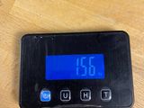 a digital clock on a table with a charger