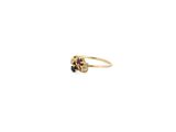 a close up of a gold ring with a red and white stone