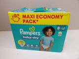 a box of diapers on a table with a baby in it