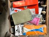 a wooden box filled with assorted items sitting on a table