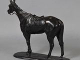 statue of a black horse with a saddle on a black base