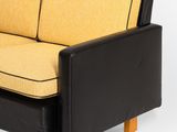 an image of a black and yellow couch on a white background
