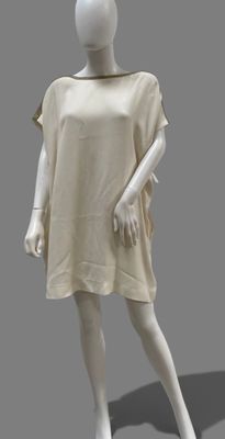 an image of a mannequin dressed in a beige dress on a gray background