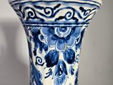 a blue and white vase sitting on a table