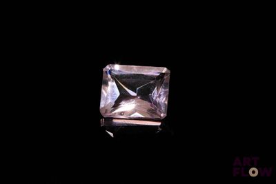 a close up of a square cut diamond on a black background