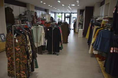 a lot of clothes that are on display in a store