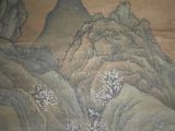 a painting on the wall of a building with mountains in the background