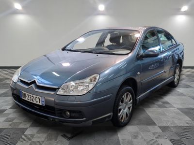 a picture of a blue car parked on a checkered floor