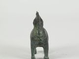 a small statue of a dog on a white surface