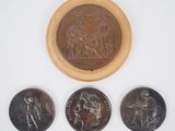 three coins and a wooden bowl with a picture of a man on a horse