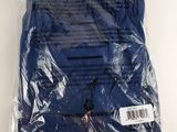 a close up of a blue shirt wrapped in plastic on a white surface